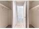 This walk-in closet features built-in shelving and access to a bathroom at 6871 Tamarus St # 204, Las Vegas, NV 89119