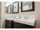 Modern bathroom featuring dual sinks with dark wood cabinets and framed mirrors at 7400 W Flamingo Rd # 1082, Las Vegas, NV 89147