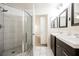 Modern bathroom featuring a glass shower and dual sinks with framed mirrors at 7400 W Flamingo Rd # 1082, Las Vegas, NV 89147