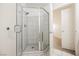 Bathroom with a modern glass shower featuring gray tile and a door to a bedroom at 7400 W Flamingo Rd # 1082, Las Vegas, NV 89147