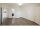 Open bedroom with wood-look floors showcasing access to the bathroom and a closet at 7400 W Flamingo Rd # 1082, Las Vegas, NV 89147