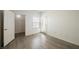 Spacious bedroom with wood-look flooring, a walk-in closet, and a sliding glass door at 7400 W Flamingo Rd # 1082, Las Vegas, NV 89147