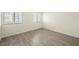 Neutral bedroom with two windows and wood-look vinyl flooring at 7400 W Flamingo Rd # 1082, Las Vegas, NV 89147
