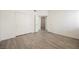 Bright bedroom with gray vinyl flooring, white walls, and ample closet space at 7400 W Flamingo Rd # 1082, Las Vegas, NV 89147