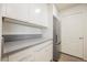 Bright kitchen showcasing white cabinets, gray countertop, and stainless steel refrigerator at 7400 W Flamingo Rd # 1082, Las Vegas, NV 89147