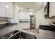 Modern kitchen featuring stainless steel appliances, white cabinets, and granite countertops at 7400 W Flamingo Rd # 1082, Las Vegas, NV 89147