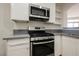 Stylish kitchen features stainless steel gas range, microwave, and sleek countertops at 7400 W Flamingo Rd # 1082, Las Vegas, NV 89147
