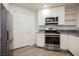 Well-lit kitchen with stainless steel oven, microwave, and ample white cabinet space at 7400 W Flamingo Rd # 1082, Las Vegas, NV 89147