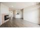 Spacious living area with fireplace, wood floors, and access to kitchen at 7400 W Flamingo Rd # 1082, Las Vegas, NV 89147