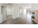 Bright open-concept living room with fireplace, wood floors, and access to the patio at 7400 W Flamingo Rd # 1082, Las Vegas, NV 89147