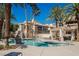 Community pool surrounded by palm trees and seating areas, perfect for relaxation and outdoor enjoyment at 7400 W Flamingo Rd # 1082, Las Vegas, NV 89147