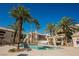 Community pool with ample seating and palm trees, creating a relaxing and enjoyable outdoor space at 7400 W Flamingo Rd # 1082, Las Vegas, NV 89147