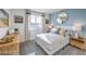 Bright bedroom with a white bed, modern decor, and a large window at 7915 Pandora Sky St # 402, North Las Vegas, NV 89084