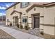 Charming exterior of home featuring a well-maintained lawn and inviting front entrance with detailed architecture at 7915 Pandora Sky St # 402, North Las Vegas, NV 89084