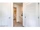 Hallway with two doors and a view of the bathroom in the distance at 7915 Pandora Sky St # 402, North Las Vegas, NV 89084