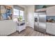 Well-lit kitchen featuring stainless steel refrigerator, white cabinets, and neutral countertops at 7915 Pandora Sky St # 402, North Las Vegas, NV 89084