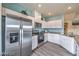 Modern kitchen boasts stainless steel appliances, ample counter space, and sleek white cabinetry at 7915 Pandora Sky St # 402, North Las Vegas, NV 89084