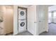 Hallway laundry closet features a stacked washer and dryer at 7915 Pandora Sky St # 402, North Las Vegas, NV 89084