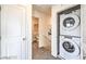 Hallway laundry closet features a stacked washer and dryer at 7915 Pandora Sky St # 402, North Las Vegas, NV 89084