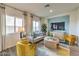 Bright living room showcasing modern furniture, large windows, and stylish decor at 7915 Pandora Sky St # 402, North Las Vegas, NV 89084