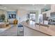 Open-concept living room features a modern kitchen and comfortable seating area with stylish decor at 7915 Pandora Sky St # 402, North Las Vegas, NV 89084