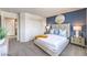 Stylish main bedroom with a large bed, modern furnishings, and a calming color palette at 7915 Pandora Sky St # 402, North Las Vegas, NV 89084