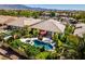 Aerial view of a home with a private backyard featuring a pool, spa, and beautifully landscaped yard at 8221 Bay Dunes St, Las Vegas, NV 89131