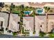 Bird's eye view of multiple properties, with focus on one backyard's custom pool, spa, and manicured landscaping at 8221 Bay Dunes St, Las Vegas, NV 89131