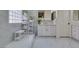 The bright bathroom features double vanities, a glass block window, and a walk-in shower at 8221 Bay Dunes St, Las Vegas, NV 89131