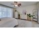 Inviting bedroom with a ceiling fan, neutral decor, and a large window for natural light at 8221 Bay Dunes St, Las Vegas, NV 89131
