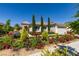 Charming home boasts lush landscaping, colorful flowerbeds, and mature trees at 8221 Bay Dunes St, Las Vegas, NV 89131