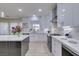 Bright, modern kitchen with white cabinets, quartz countertops, and stainless steel appliances at 8221 Bay Dunes St, Las Vegas, NV 89131