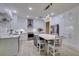 Modern white kitchen featuring island seating, stainless appliances, and open layout at 8221 Bay Dunes St, Las Vegas, NV 89131