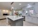 Beautiful kitchen with island seating, white cabinets, and backyard view through window at 8221 Bay Dunes St, Las Vegas, NV 89131