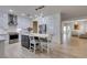 Stylish kitchen with island seating, stainless steel appliances, and open layout to living room at 8221 Bay Dunes St, Las Vegas, NV 89131