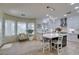 Modern white kitchen with island seating, stainless steel appliances, and bright lighting at 8221 Bay Dunes St, Las Vegas, NV 89131