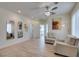 Light filled living room with ceiling fan, tile floors, neutral walls, and furniture at 8221 Bay Dunes St, Las Vegas, NV 89131