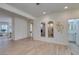 Spacious living room featuring light wood floors, arched mirrors, and modern decor at 8221 Bay Dunes St, Las Vegas, NV 89131