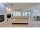 Open-concept living room with fireplace, kitchen, and dining area at 8221 Bay Dunes St, Las Vegas, NV 89131