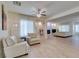 Spacious living room with fireplace, tile floors, ceiling fan, and natural light at 8221 Bay Dunes St, Las Vegas, NV 89131