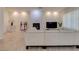 Inviting living room with fireplace, white stone accent wall, and wood-style tile flooring at 8221 Bay Dunes St, Las Vegas, NV 89131