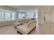 Open-concept living area with sofa, kitchen, and lots of natural light at 8221 Bay Dunes St, Las Vegas, NV 89131