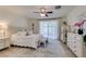 Serene primary bedroom features a ceiling fan, natural light, and a cozy bench at the foot of the bed at 8221 Bay Dunes St, Las Vegas, NV 89131