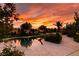 Backyard pool and deck offer a scenic view of the colorful sunset sky at 8221 Bay Dunes St, Las Vegas, NV 89131