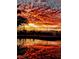 Sunset reflecting over the community pool with a metal safety fence at 8221 Bay Dunes St, Las Vegas, NV 89131