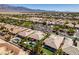 Birds eye view showcasing homes in a neighborhood, lush landscaping, and blue skies at 8221 Bay Dunes St, Las Vegas, NV 89131