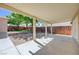Spacious covered patio overlooking a well-maintained backyard with trees and a fence at 839 Benita Pl, Boulder City, NV 89005