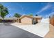 View of backyard with covered patio, driveway, and minimal landscaping, perfect for low maintenance and outdoor enjoyment at 839 Benita Pl, Boulder City, NV 89005