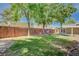 Serene backyard featuring mature trees, green grass, a hammock, and a covered patio for relaxation and outdoor enjoyment at 839 Benita Pl, Boulder City, NV 89005