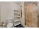 Bright bathroom featuring a tiled shower, sleek toilet, and convenient decorative storage ladder at 839 Benita Pl, Boulder City, NV 89005